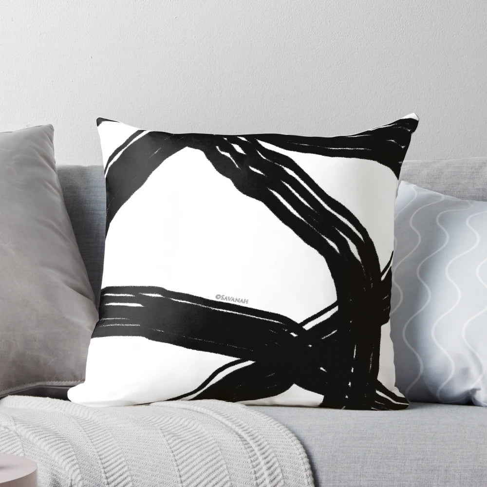 Elegant black and white throw pillow with a modern, minimalist design