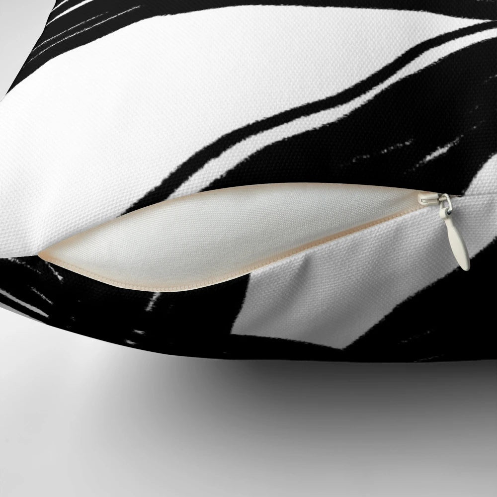 Elegant black and white throw pillow with a modern, minimalist design