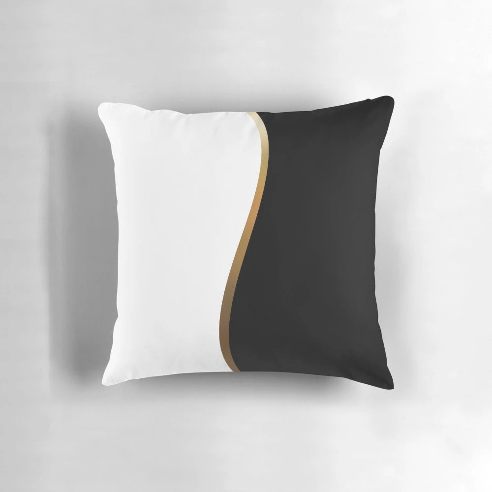 Closeup of a black and white decorative pillow with a bold gold wave pattern.