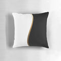 Closeup of a black and white decorative pillow with a bold gold wave pattern.