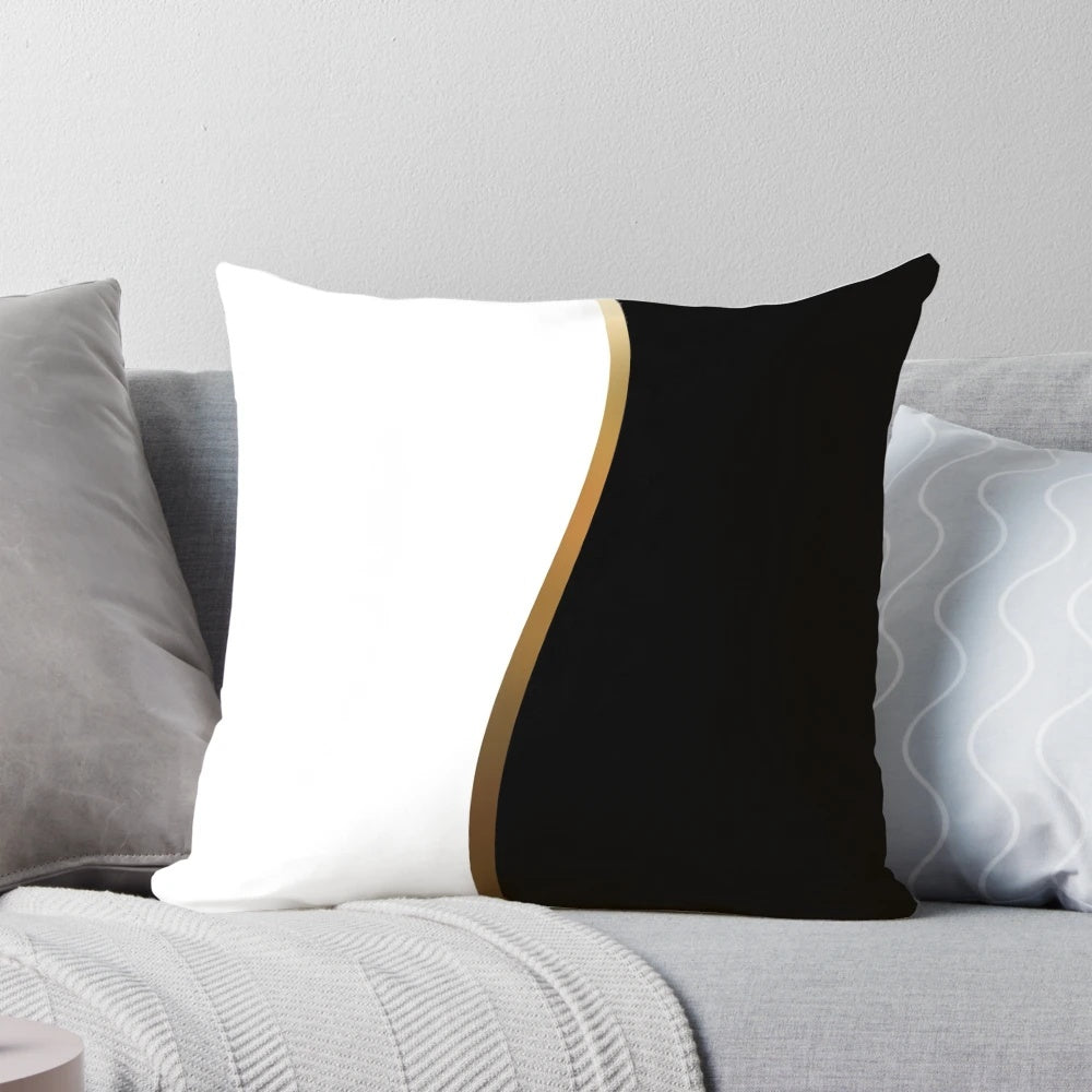 Closeup of a black and white decorative pillow with a bold gold wave pattern.