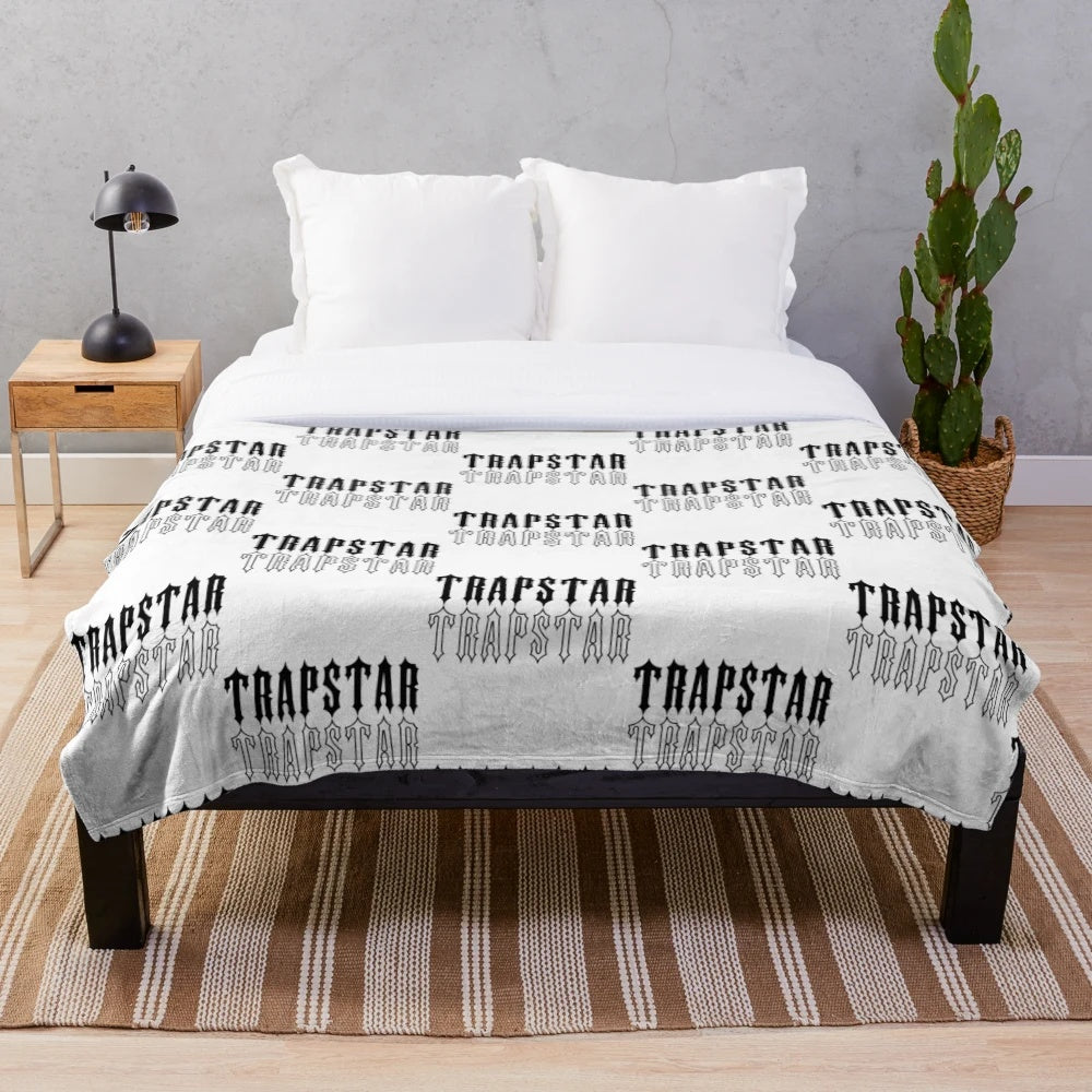 Black and white plush blanket with Trapstar-inspired design