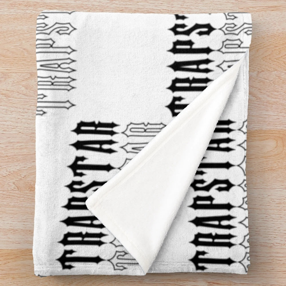 Black and white plush blanket with Trapstar-inspired design