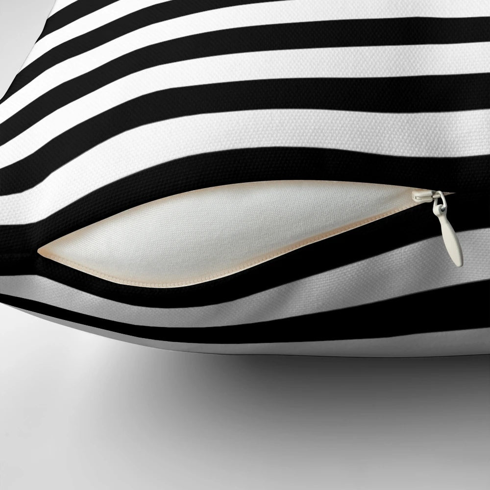 Black and white striped duvet cover and pillows on a bed
