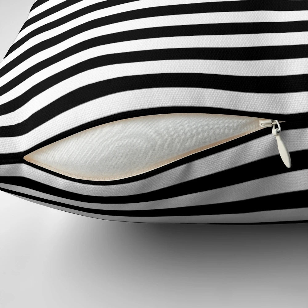 Black and white striped decorative pillow with modern, minimalist design