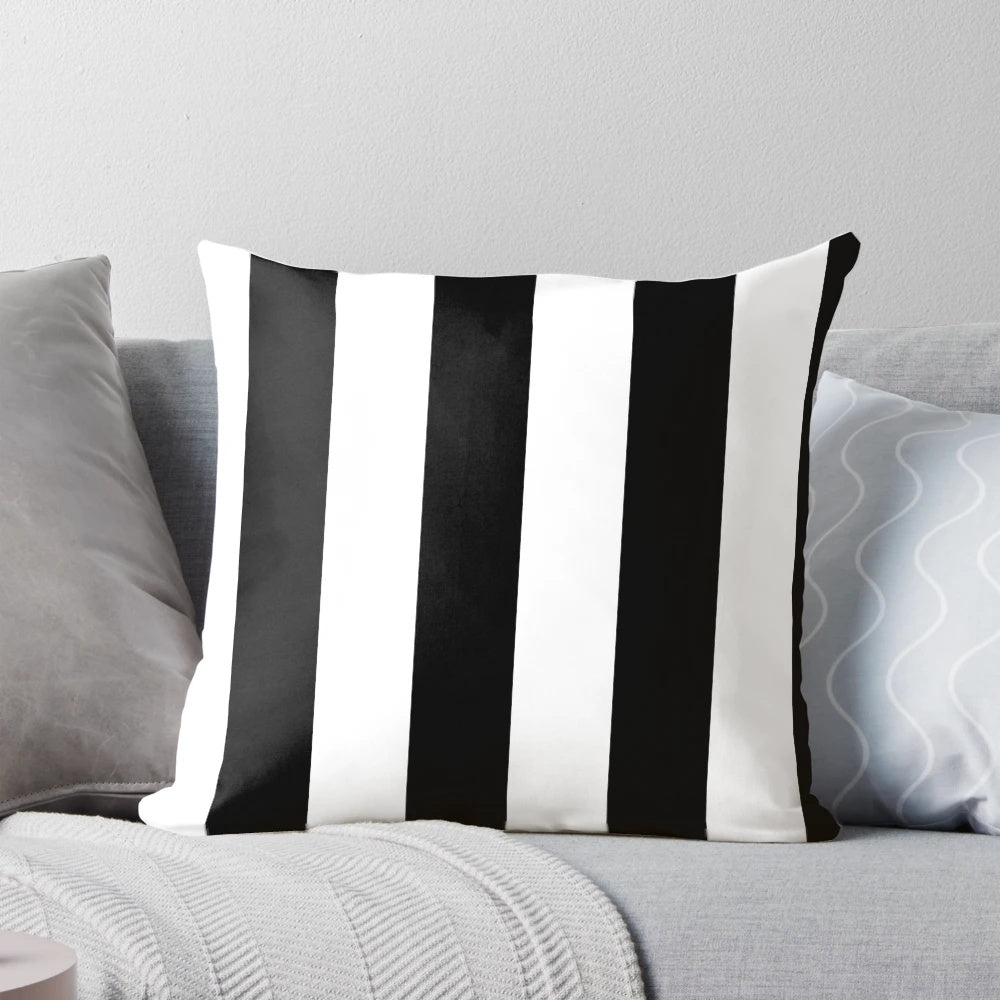Black and white vertical striped pillow with a minimalist, modern design