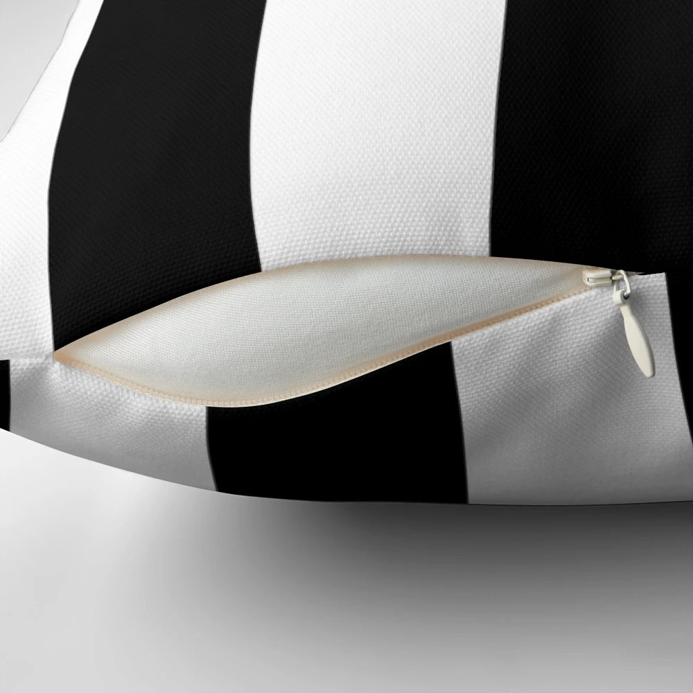 Black and white vertical striped pillow with a minimalist, modern design