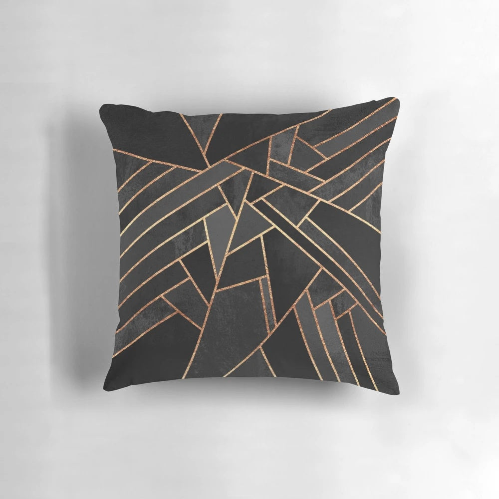 Black and copper geometric pattern pillow with abstract lines and shapes