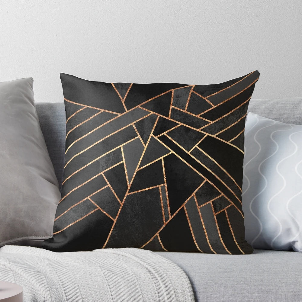 Black and copper geometric pattern pillow with abstract lines and shapes