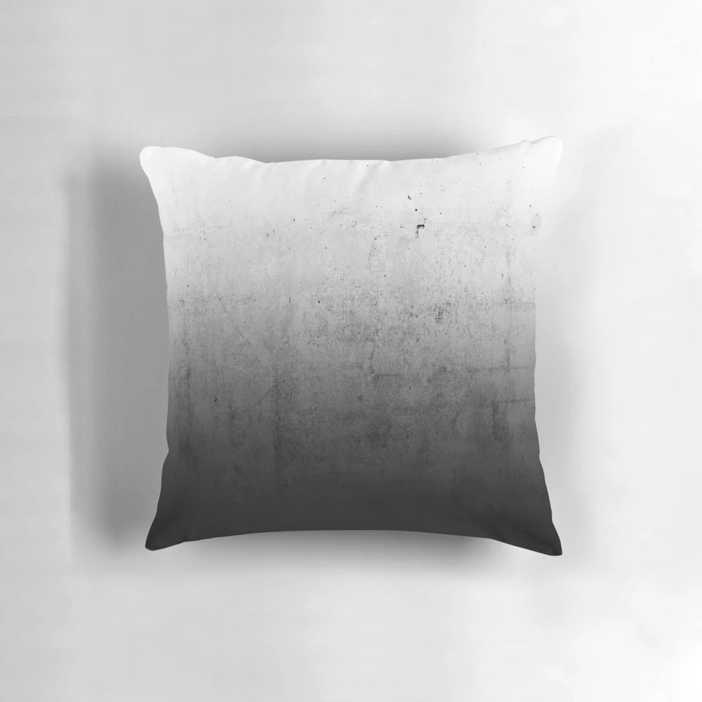 Black and white ombre pattern on a concrete-textured pillow