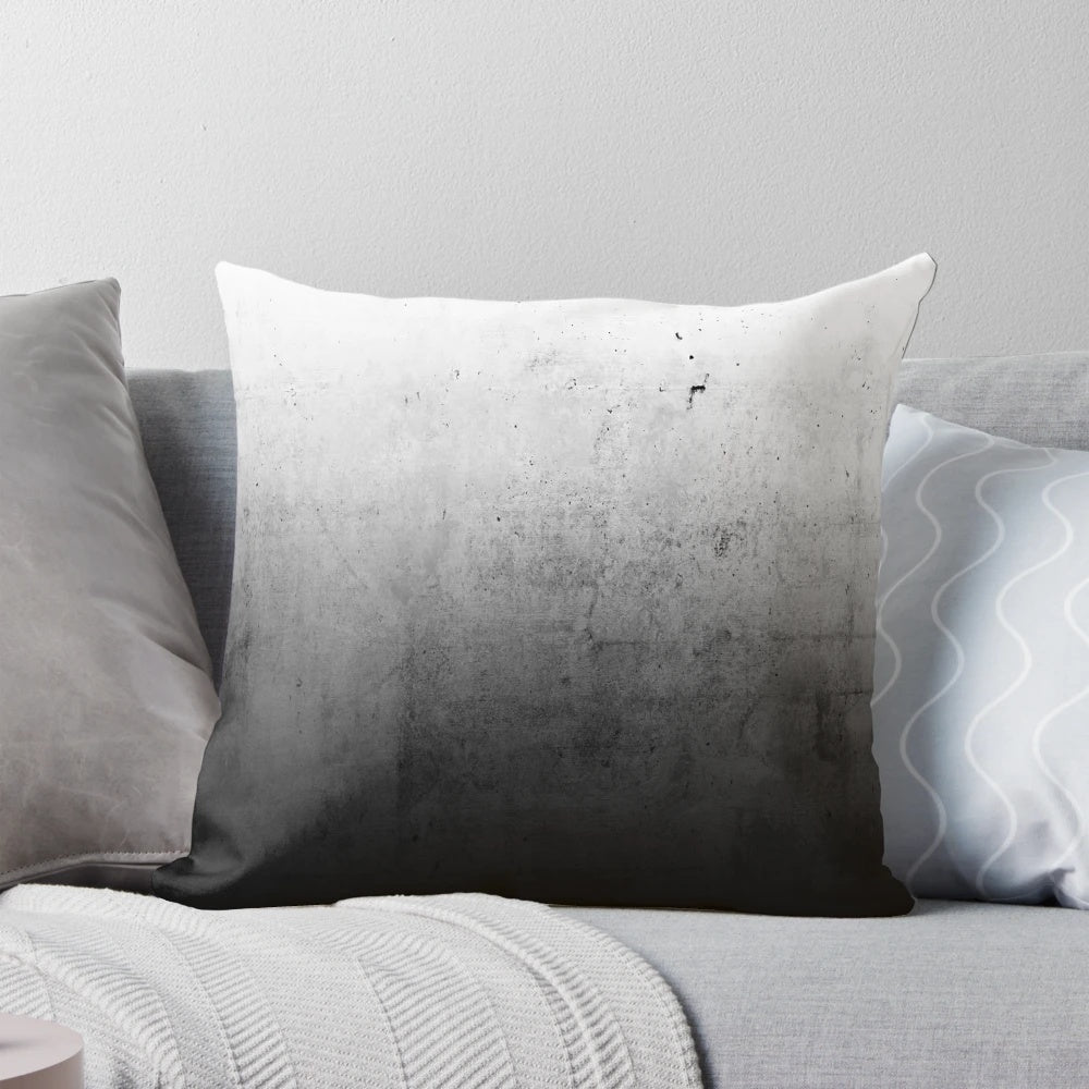 Black and white ombre pattern on a concrete-textured pillow