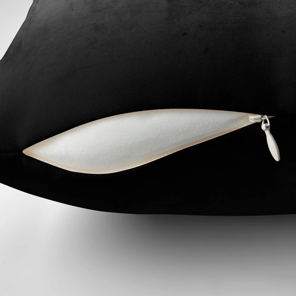 Black and white ombre pattern on a concrete-textured pillow