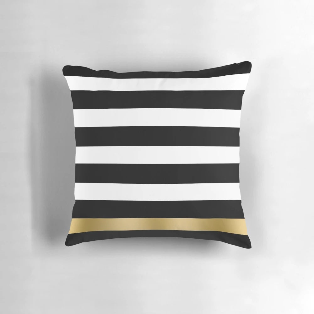 Black, white and gold striped decorative throw pillow with a modern geometric pattern