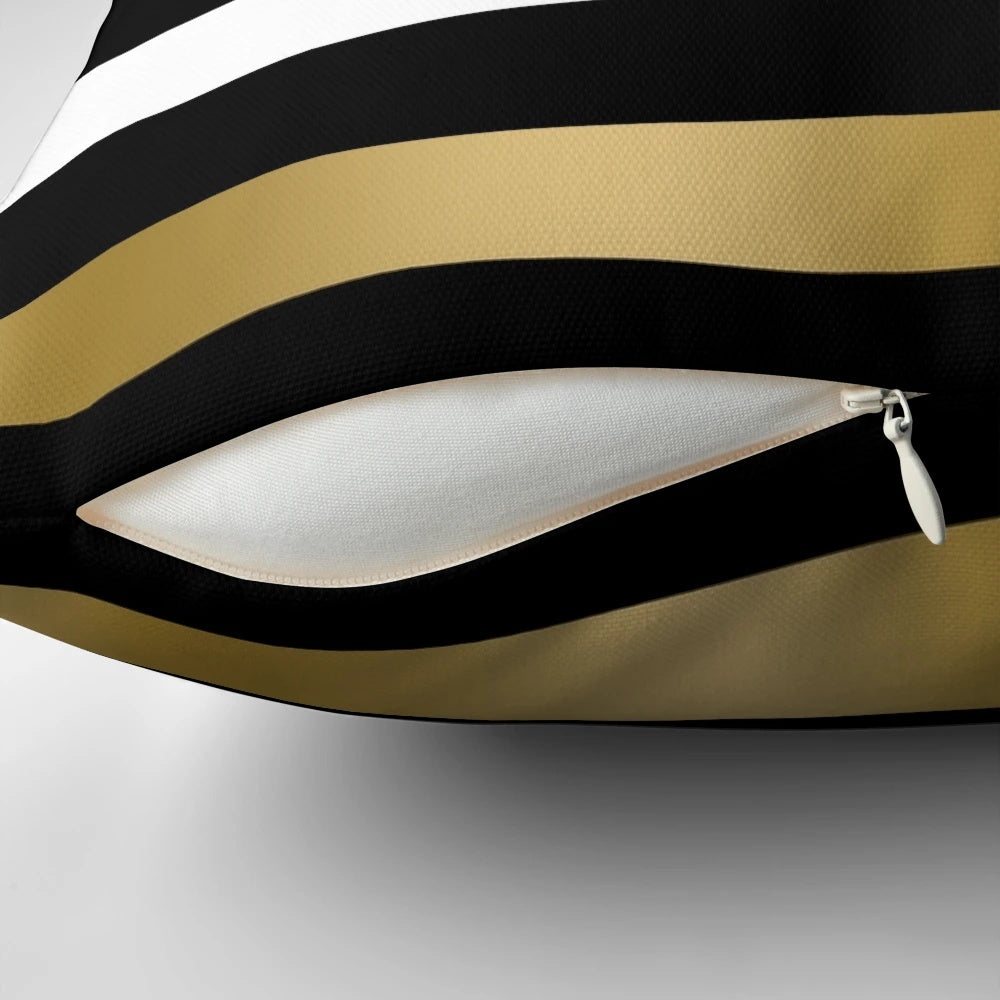 Black, white and gold striped decorative throw pillow with a modern geometric pattern