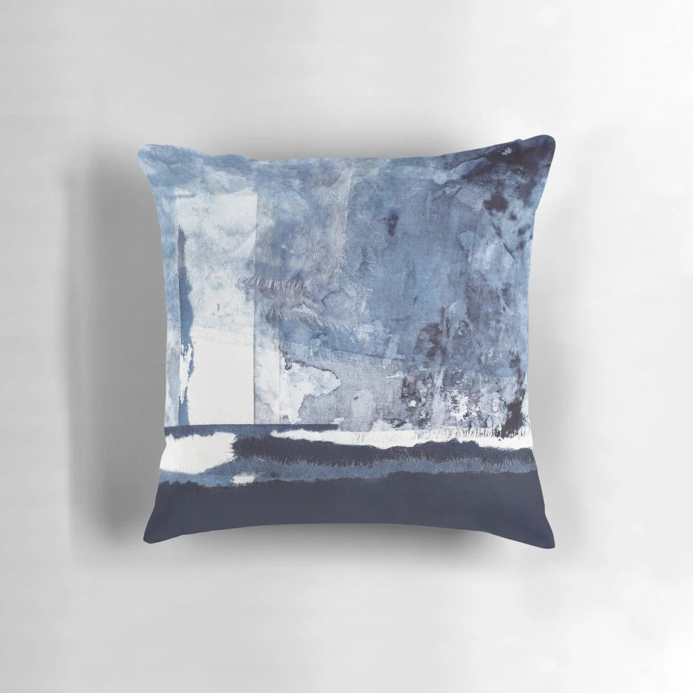 Blue and white abstract art pillow with a modern, minimalist design