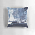 Blue and white abstract art pillow with a modern, minimalist design