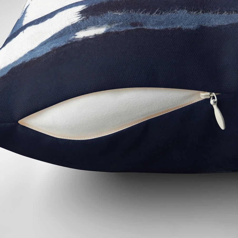 Blue and white abstract art pillow with a modern, minimalist design