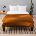 Brushed copper plush blanket with metallic sheen and elegant illustration