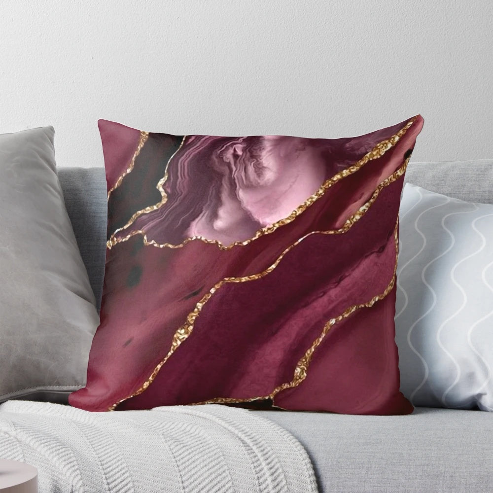Burgundy and gold abstract patterned decorative pillow