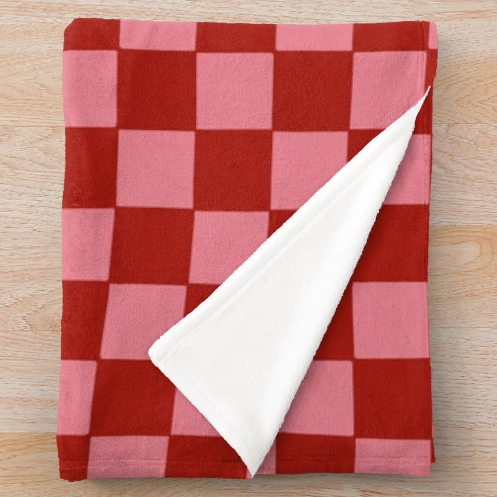 Pink and red checkered plush blanket