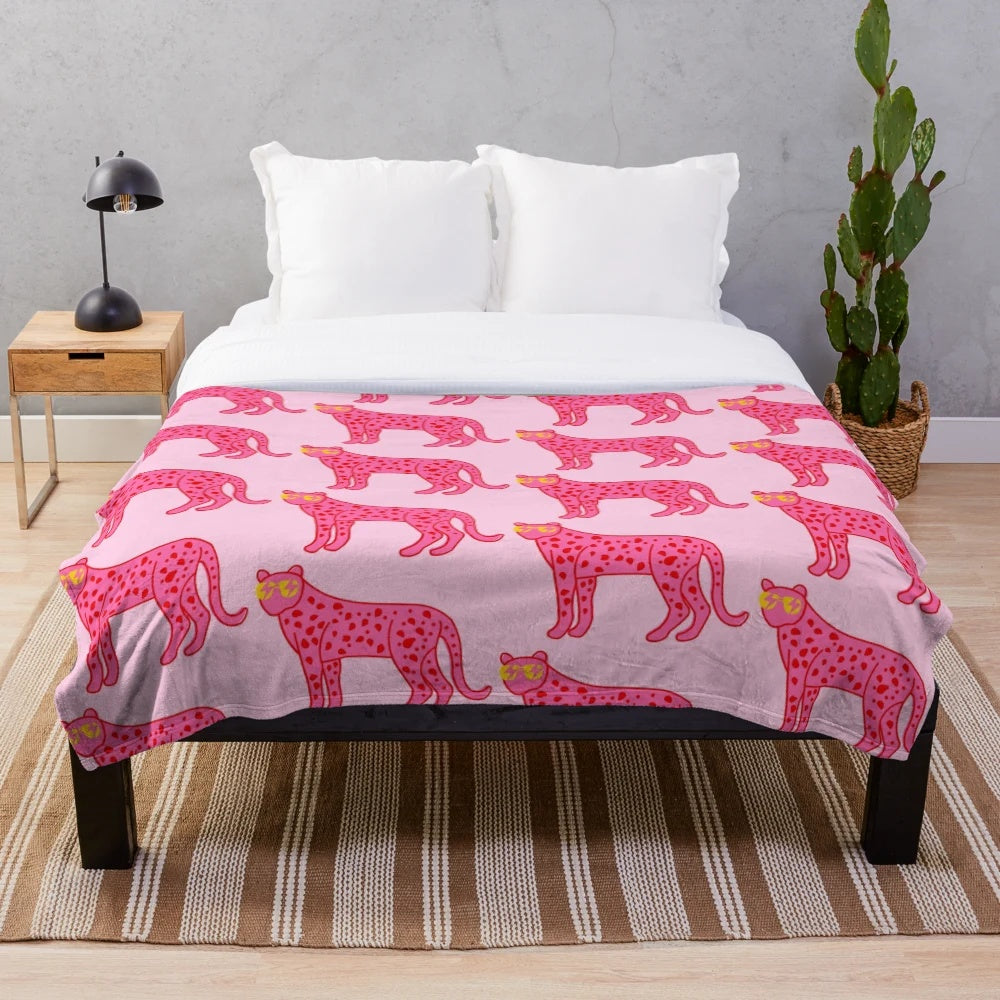 Cheetah print plush blanket with pink and red accents, sunglasses, and lightning bolt eyes