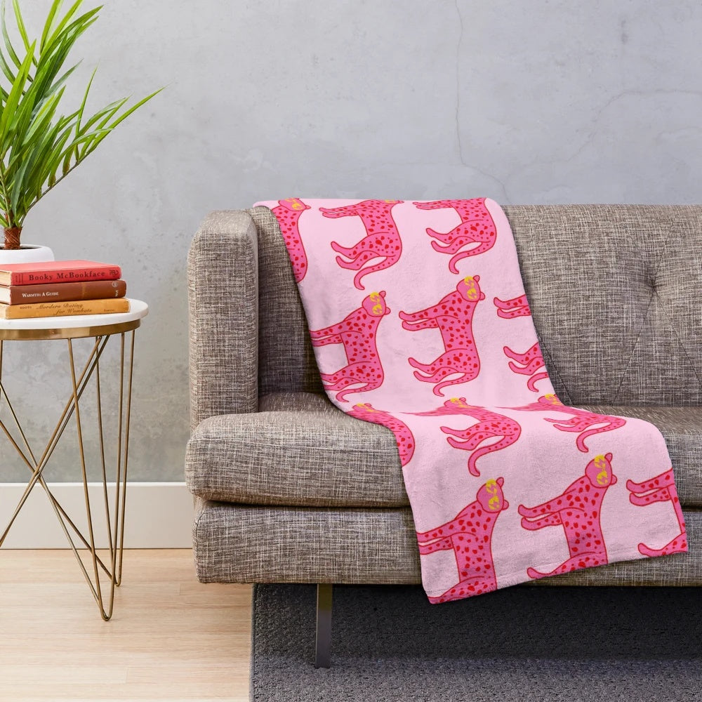 Cheetah print plush blanket with pink and red accents, sunglasses, and lightning bolt eyes