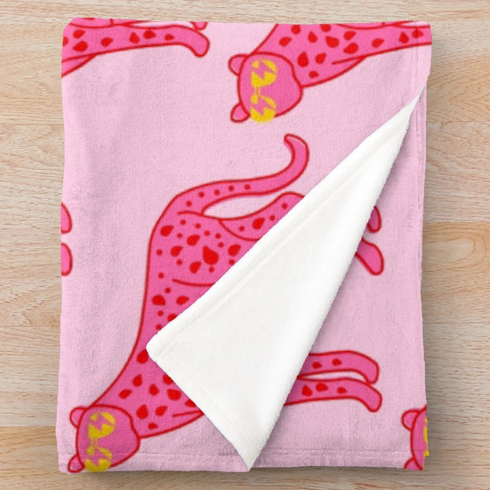 Cheetah print plush blanket with pink and red accents, sunglasses, and lightning bolt eyes