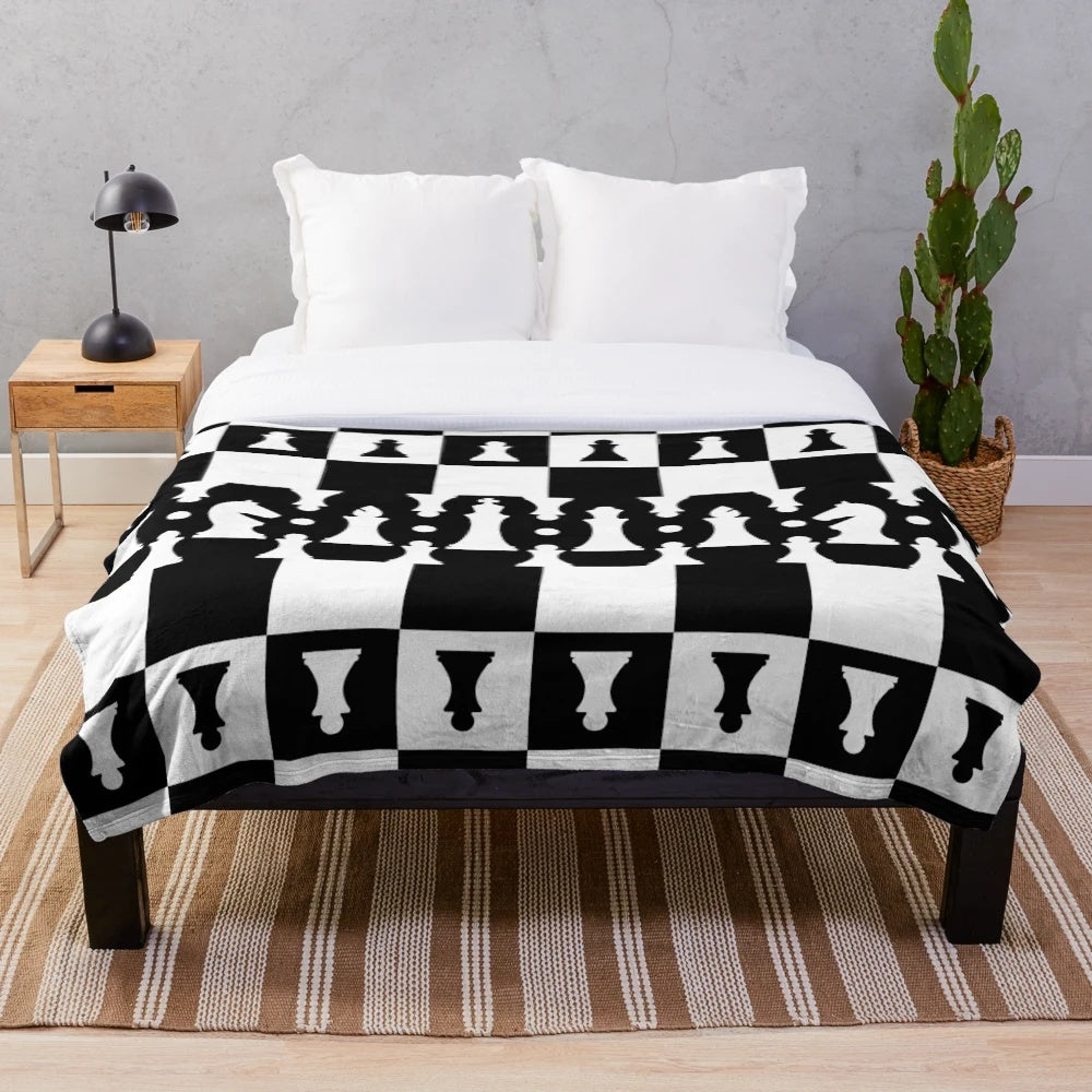 Plush blanket featuring a chess pieces pattern in black and white