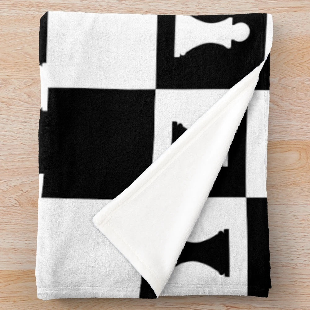 Plush blanket featuring a chess pieces pattern in black and white