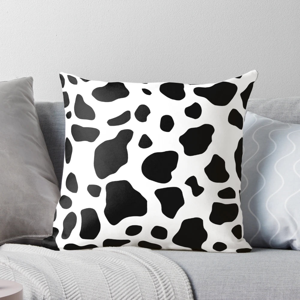 Cow print pillow with a neutral color scheme and soft texture