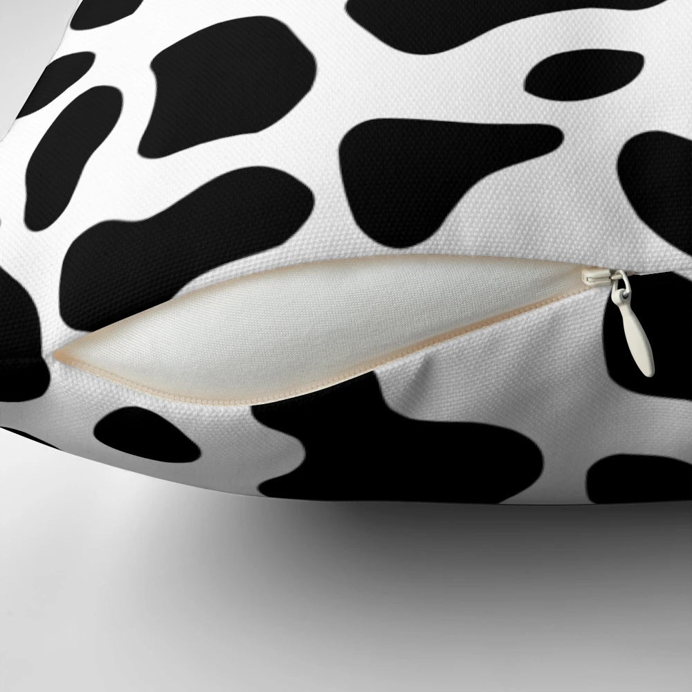 Cow print pillow with a neutral color scheme and soft texture