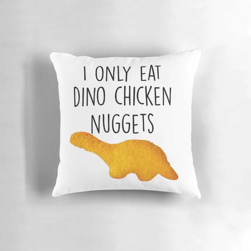 A soft and cozy pillow featuring a playful dinosaur design, perfect for fans of dinosaurs and chicken nuggets.