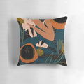Vibrant evening meadow-inspired pillow with a modern floral pattern in shades of orange and blue.