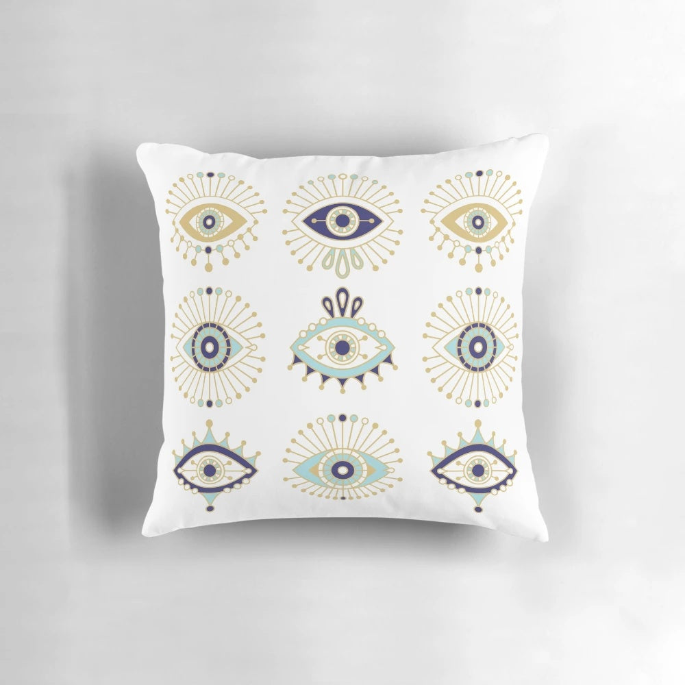 Decorative white pillow featuring a vibrant blue evil eye design