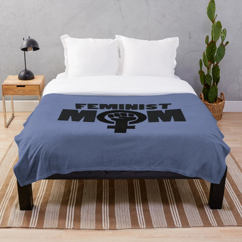 Soft and cozy plush blanket featuring a feminist mom design