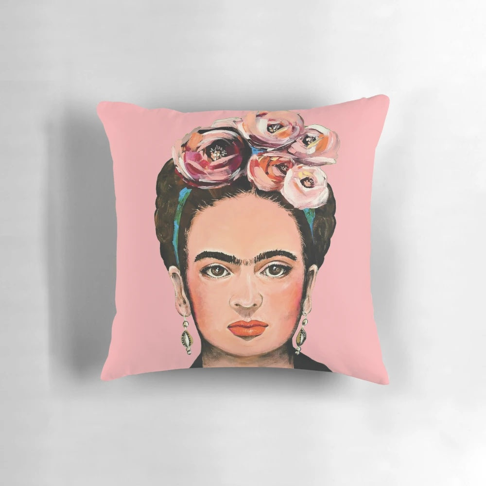 Pink floral throw pillow featuring a portrait of Frida Kahlo