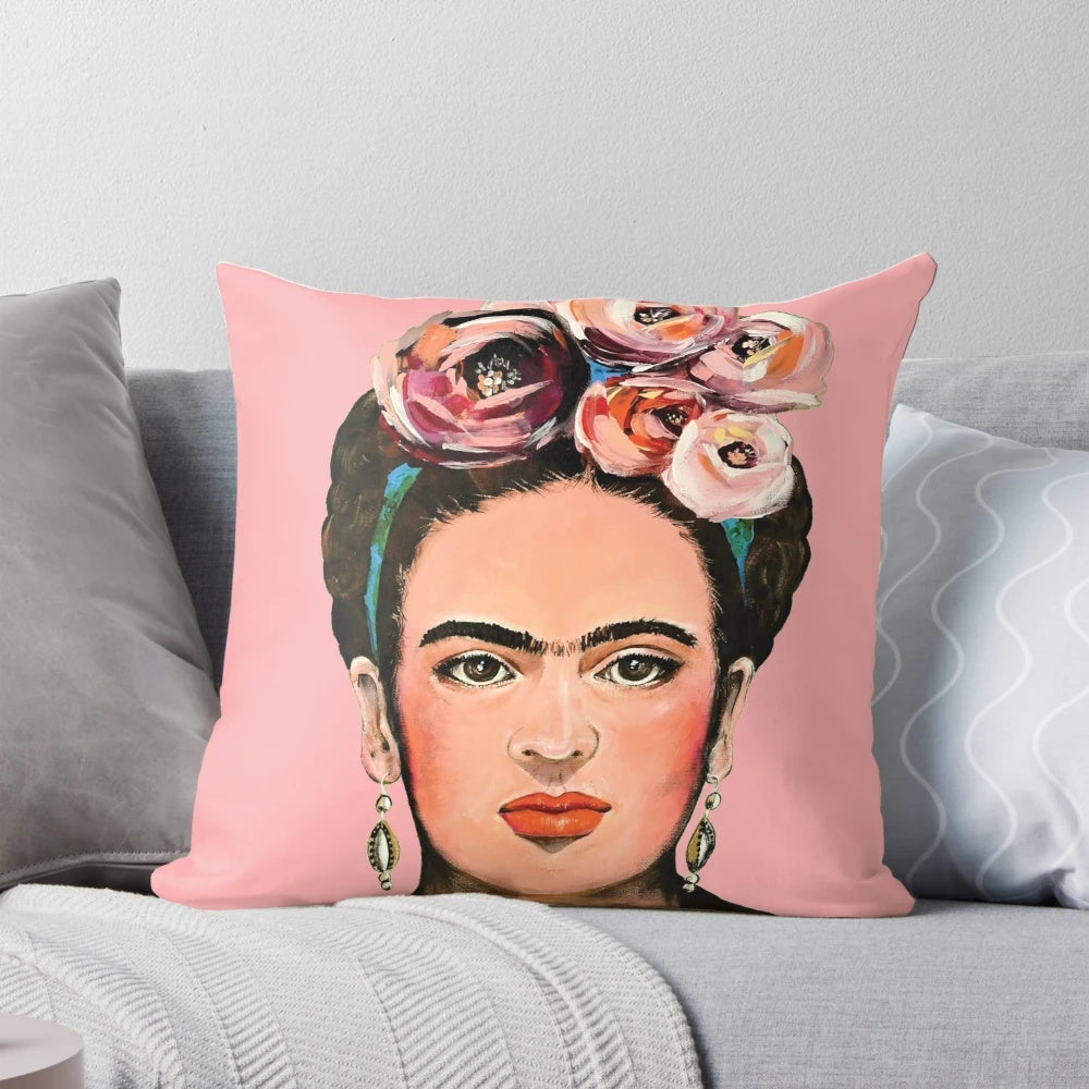 Pink floral throw pillow featuring a portrait of Frida Kahlo