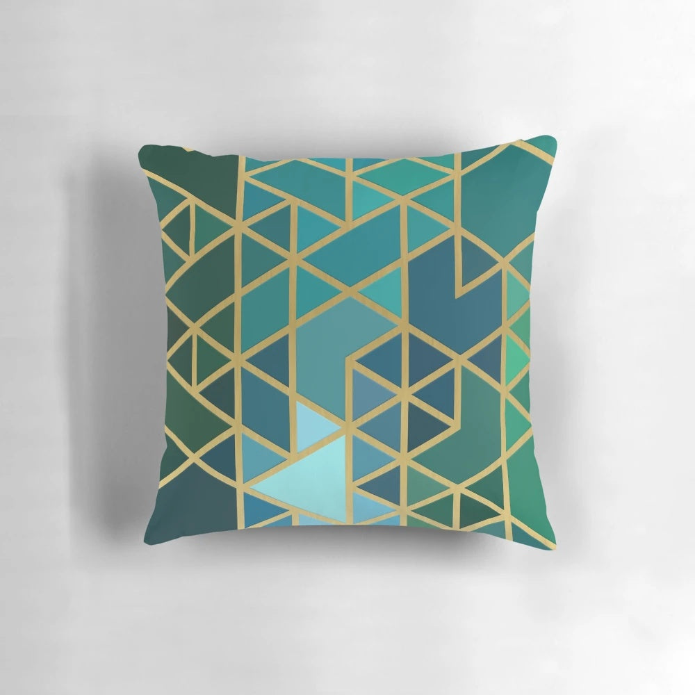 Geometric pattern pillow in gold, green, and blue colors with a modern, abstract design