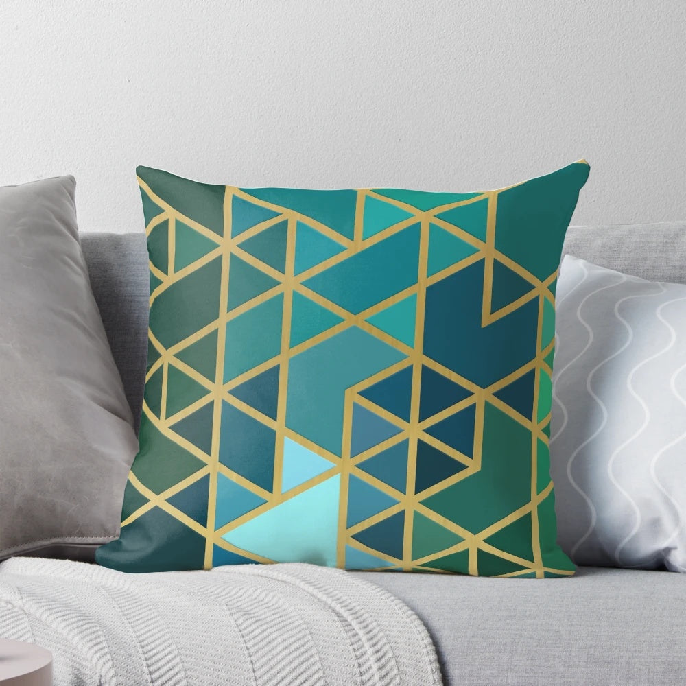 Geometric pattern pillow in gold, green, and blue colors with a modern, abstract design