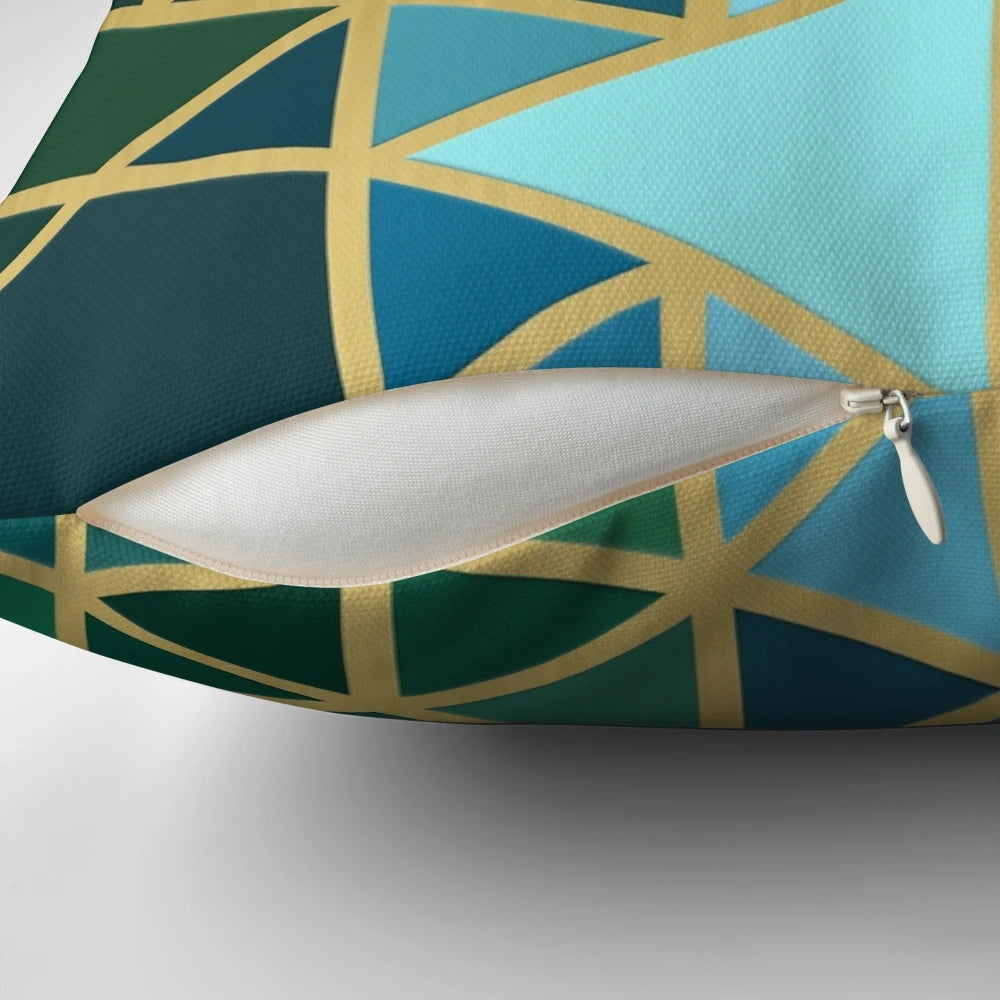 Geometric pattern pillow in gold, green, and blue colors with a modern, abstract design