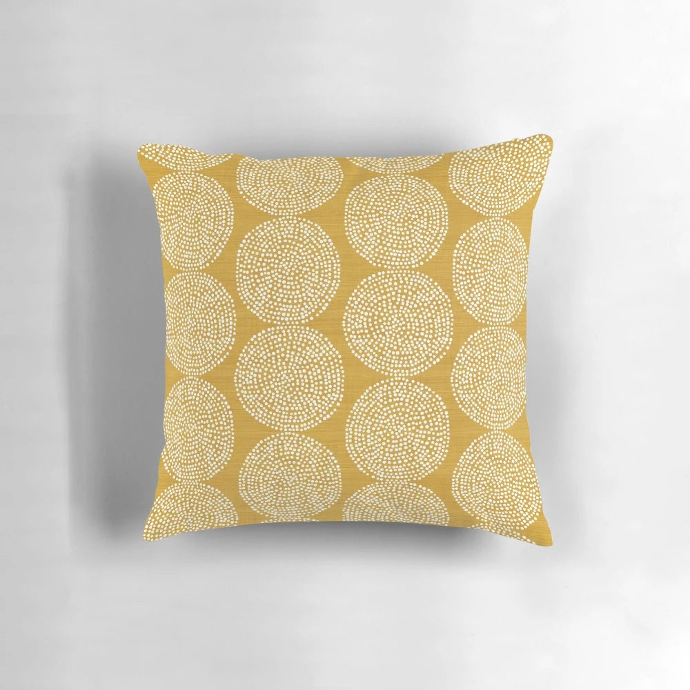 Gold, geometric, and bohemian-inspired pillow in a beige and brown color scheme.