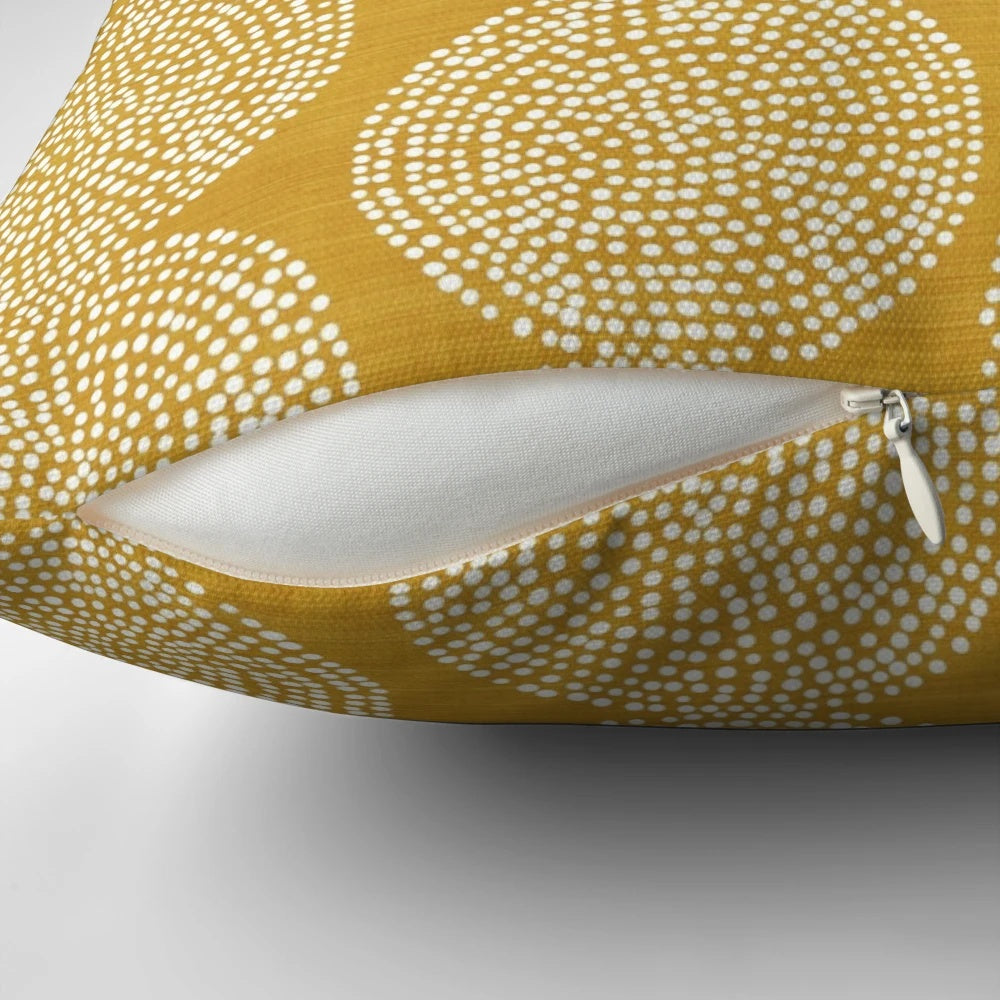 Gold, geometric, and bohemian-inspired pillow in a beige and brown color scheme.