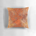 Gold and rust swirl pattern on a decorative throw pillow