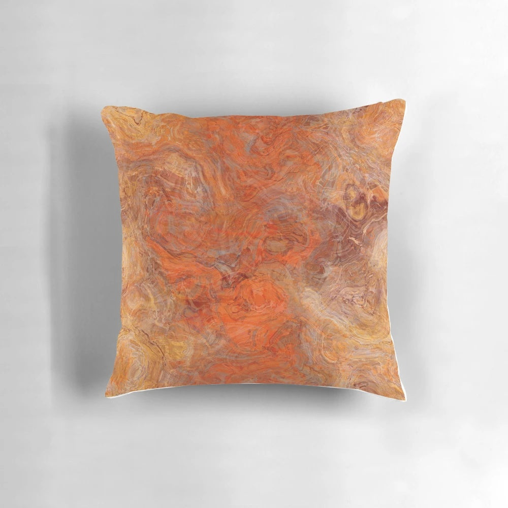 Gold and rust swirl pattern on a decorative throw pillow
