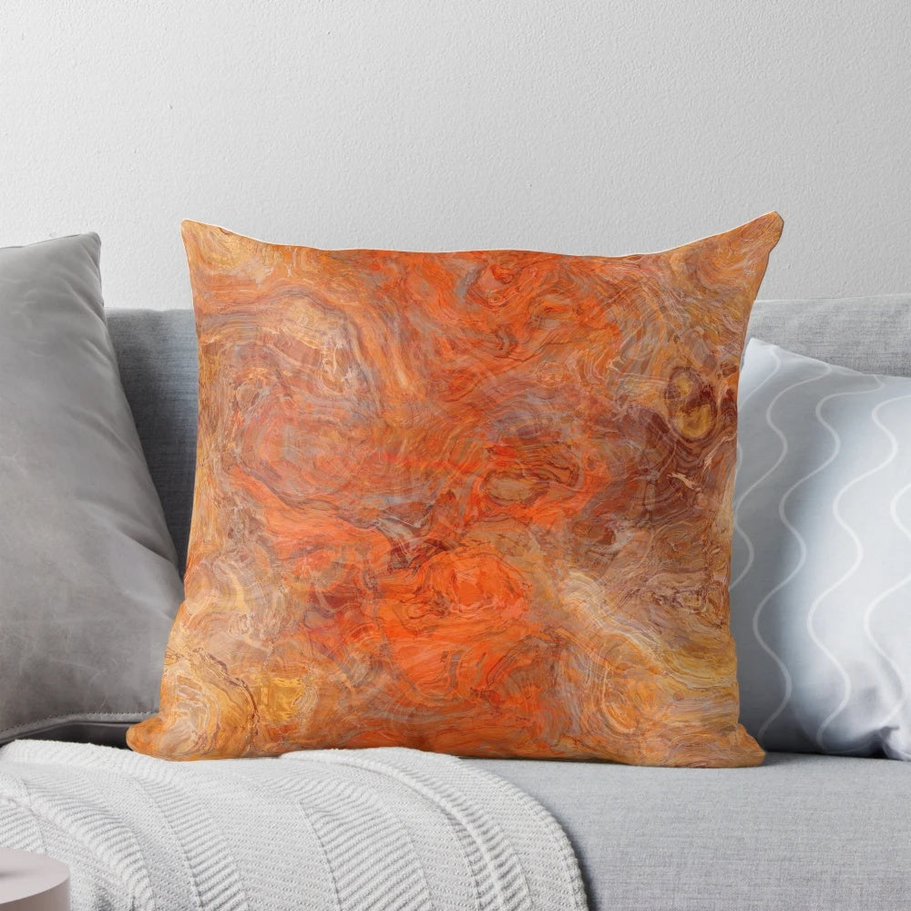 Gold and rust swirl pattern on a decorative throw pillow