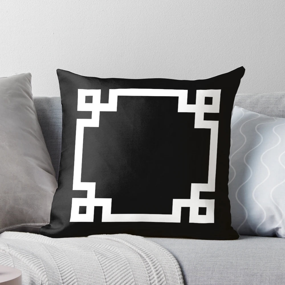 Black and white square pillow with a classic Greek key design, perfect for adding a touch of modern elegance to any room.