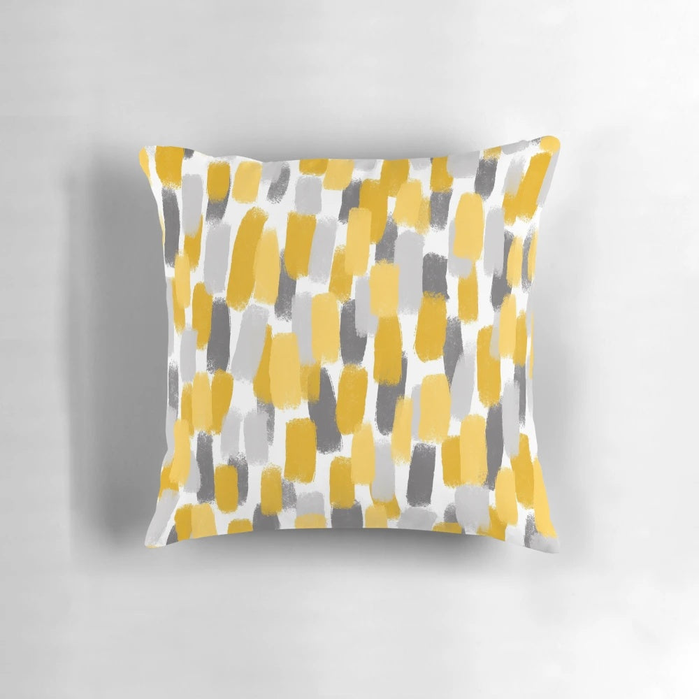 Grey and mustard yellow pillow with abstract paint brush strokes
