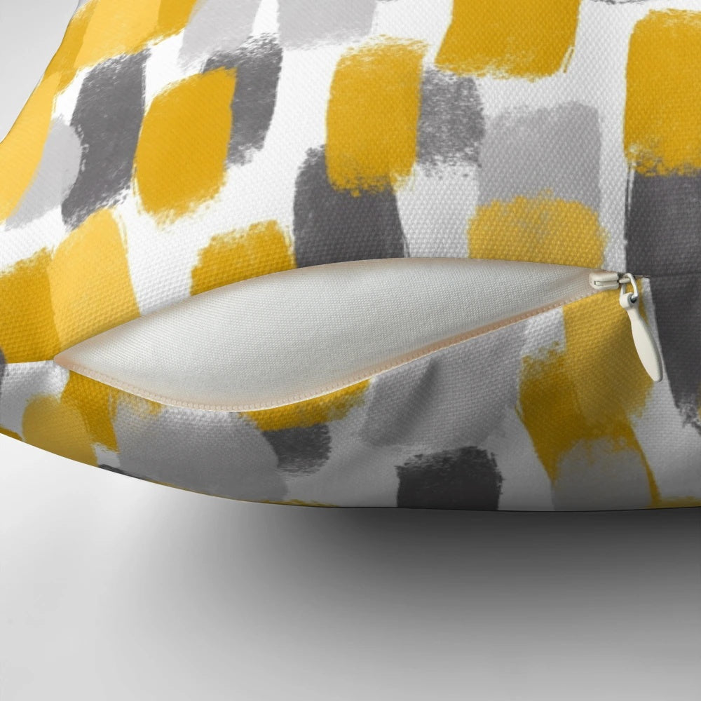 Grey and mustard yellow pillow with abstract paint brush strokes