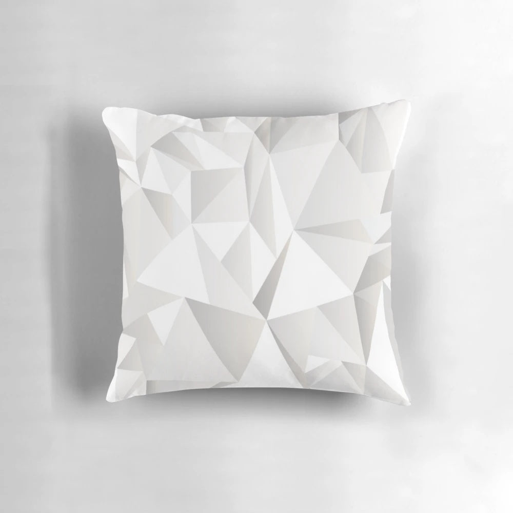 Soft, grey decorative pillow with a modern pattern of lines, triangles, and butterflies