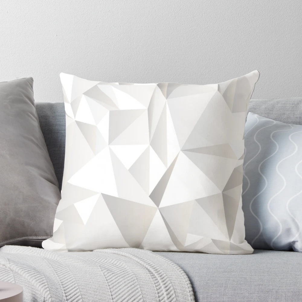 Soft, grey decorative pillow with a modern pattern of lines, triangles, and butterflies